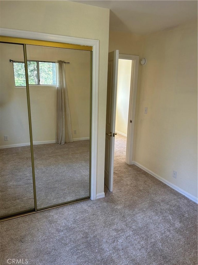 unfurnished bedroom featuring a closet and carpet floors