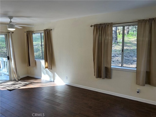 spare room with ceiling fan and plenty of natural light