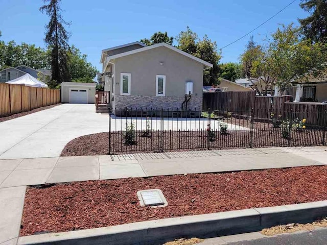 view of front of property with a garage and an outdoor structure