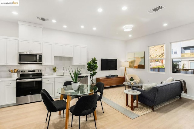 interior space featuring sink and light hardwood / wood-style floors