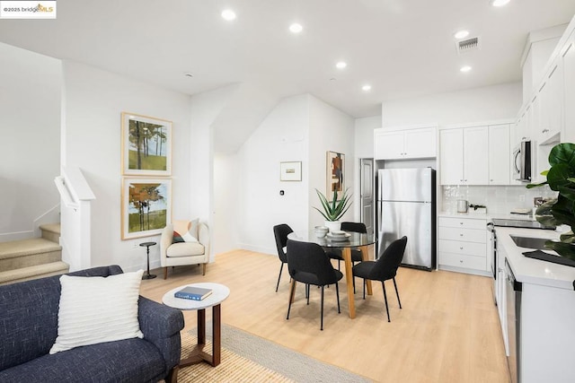 dining room with light hardwood / wood-style flooring