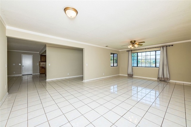 empty room with ceiling fan, crown molding, and light tile patterned flooring