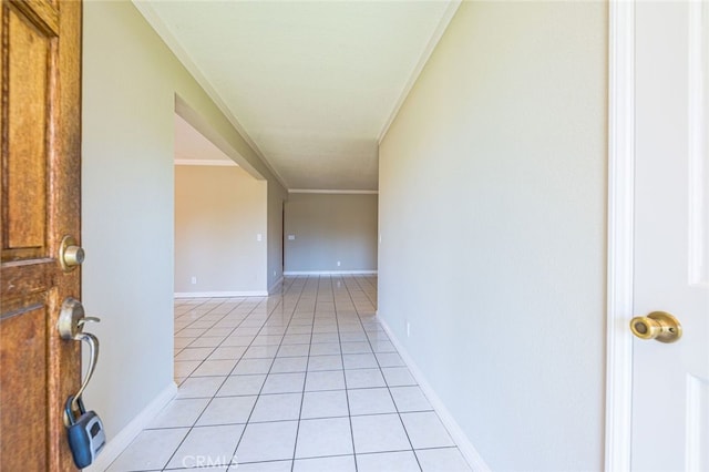 hallway with light tile patterned flooring and ornamental molding