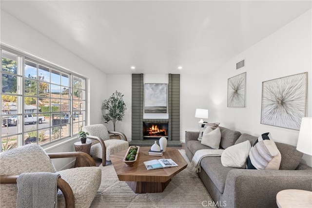 living room with a brick fireplace