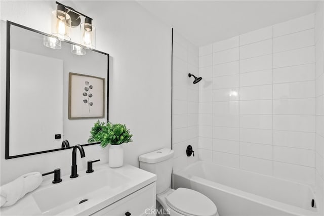 full bathroom featuring toilet, vanity, and tiled shower / bath