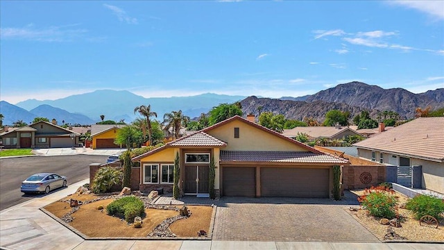 ranch-style home with a mountain view and a garage