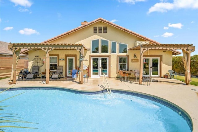 back of property featuring a pergola, french doors, and a patio