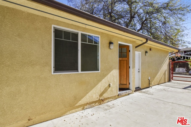 property entrance featuring a patio area