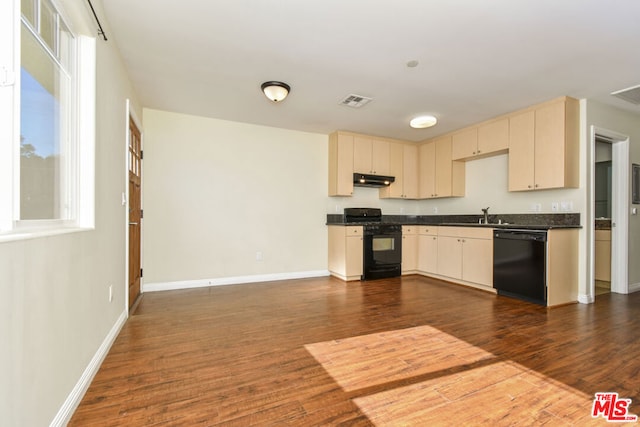 kitchen with dark wood-type flooring, black appliances, sink, and cream cabinets