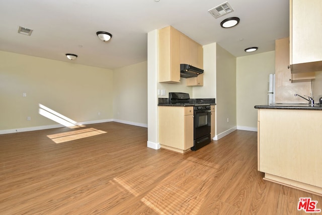 kitchen with extractor fan, light hardwood / wood-style floors, sink, black gas stove, and light brown cabinetry