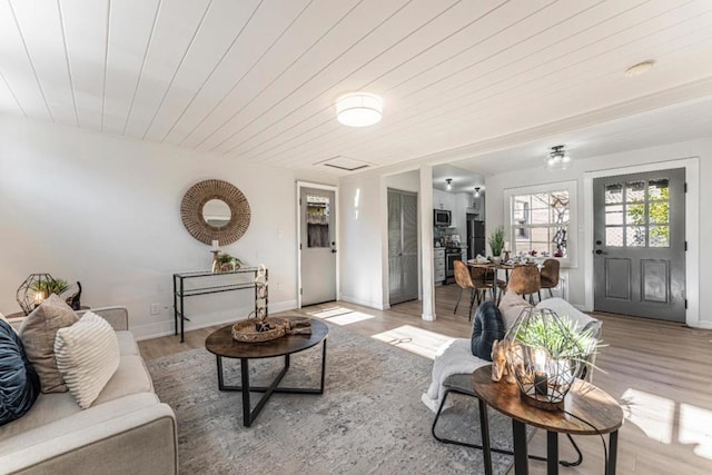 living room with wooden ceiling and light hardwood / wood-style flooring