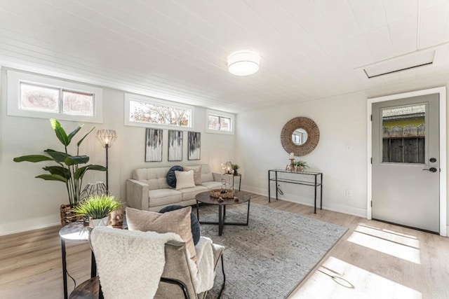 living room with light hardwood / wood-style flooring and a wealth of natural light