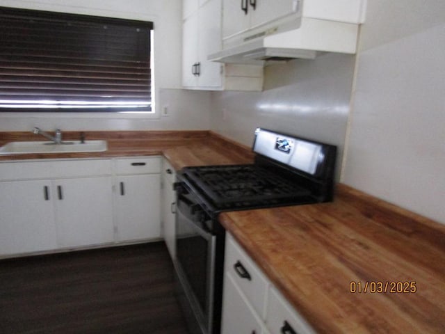 kitchen featuring sink, black electric range oven, white cabinetry, dark wood-type flooring, and wood counters