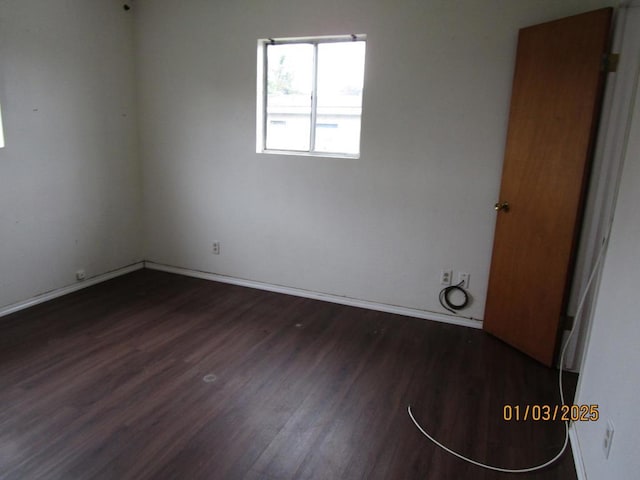 unfurnished room featuring dark hardwood / wood-style floors