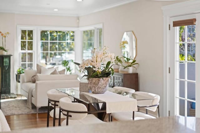 dining room with hardwood / wood-style flooring and ornamental molding