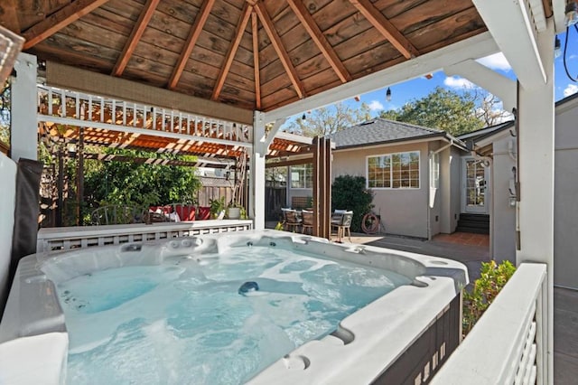 exterior space featuring a gazebo and a hot tub