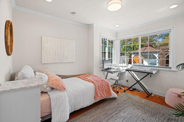 bedroom featuring hardwood / wood-style flooring and ornamental molding