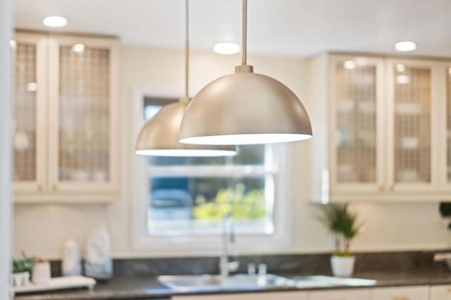 room details featuring decorative light fixtures and sink