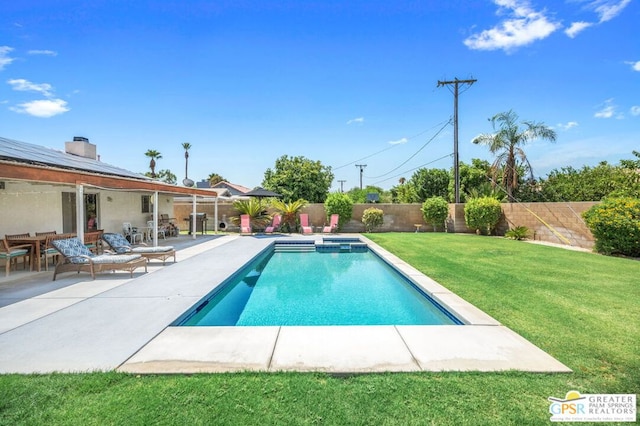 view of swimming pool with a patio area and a yard