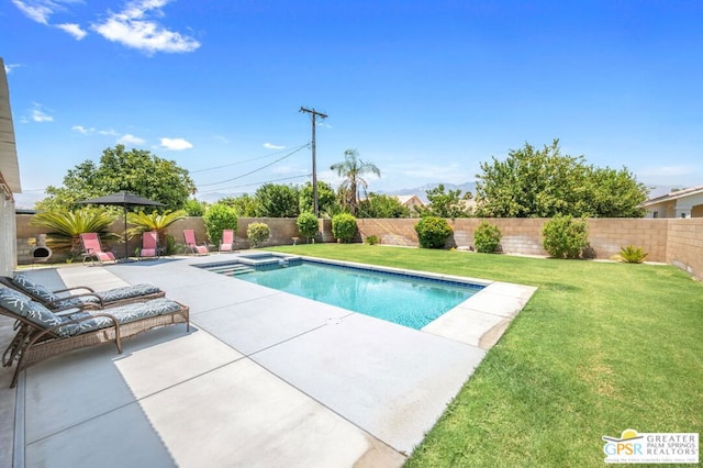 view of pool featuring a yard, a patio, and an in ground hot tub