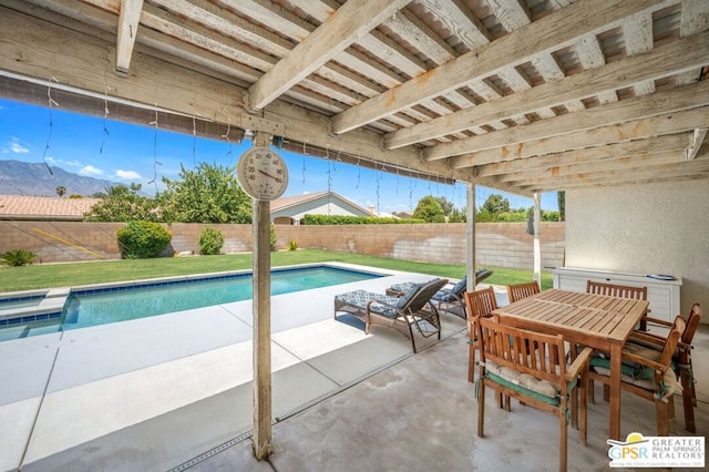 view of swimming pool featuring a patio area and a mountain view