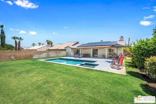 view of swimming pool featuring an in ground hot tub, a patio area, and a yard