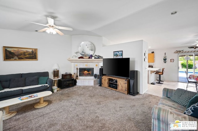 living room featuring light carpet, ceiling fan, and vaulted ceiling