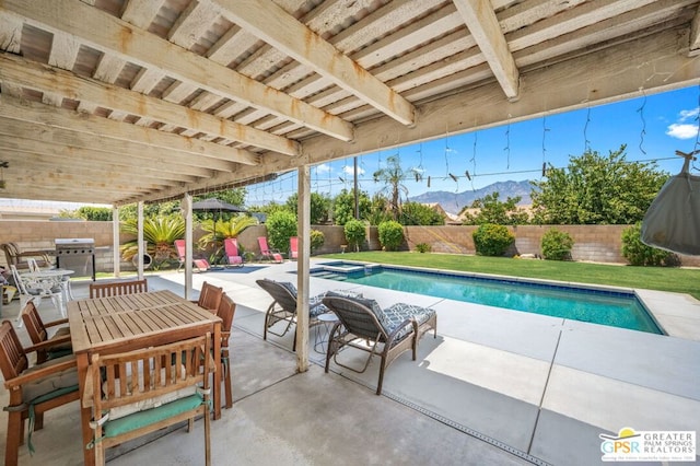 view of swimming pool with a mountain view and a patio area