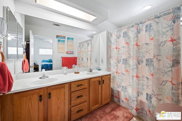 bathroom with vanity and a shower with shower curtain