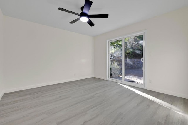 empty room with light wood-type flooring and ceiling fan