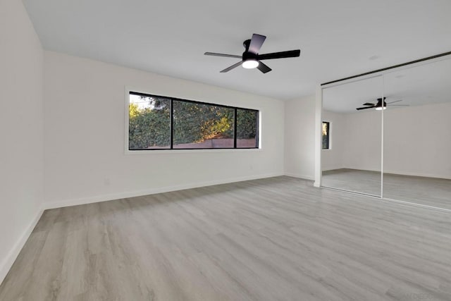 unfurnished bedroom with light wood-type flooring, a closet, and ceiling fan