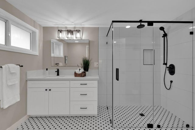 bathroom featuring a shower with door, vanity, and tile patterned flooring