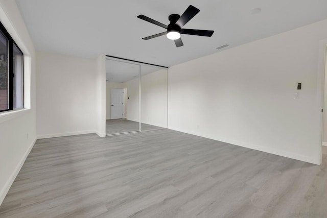 unfurnished room with ceiling fan and light hardwood / wood-style flooring