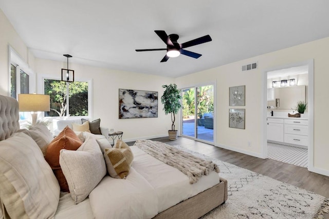 bedroom with multiple windows, connected bathroom, access to outside, ceiling fan, and light hardwood / wood-style flooring