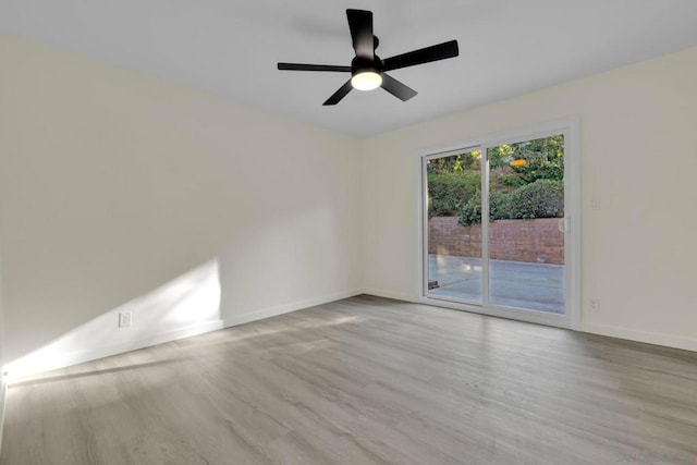 empty room with ceiling fan and light hardwood / wood-style floors