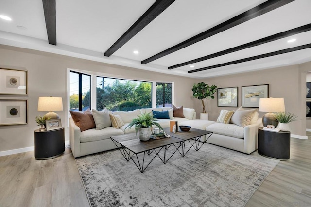 living room with beamed ceiling and light wood-type flooring