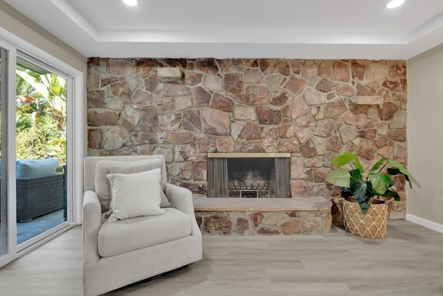 living area featuring hardwood / wood-style floors and a fireplace