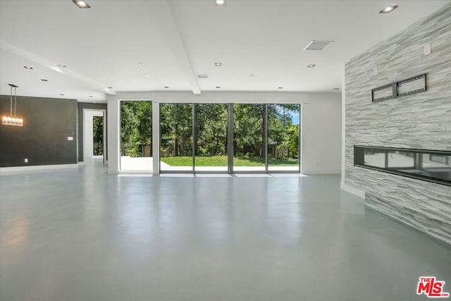 unfurnished living room featuring a tile fireplace