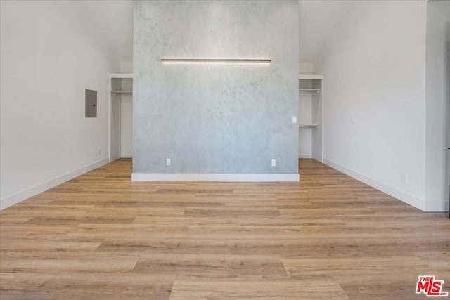 spare room featuring light wood-type flooring and electric panel