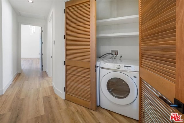 laundry area featuring light hardwood / wood-style floors and washer / clothes dryer