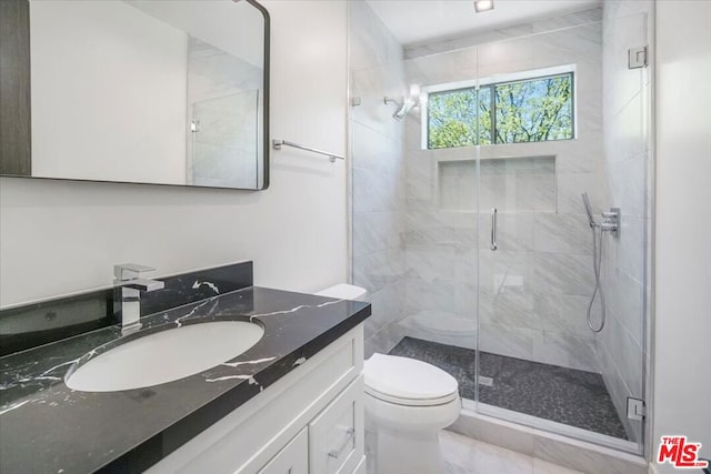 bathroom with toilet, vanity, and walk in shower