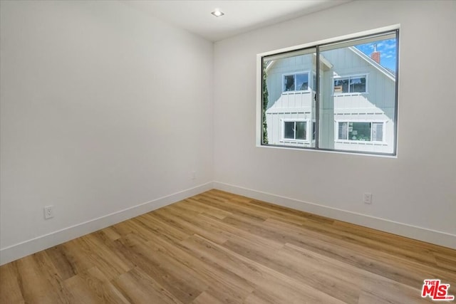 spare room with light hardwood / wood-style flooring