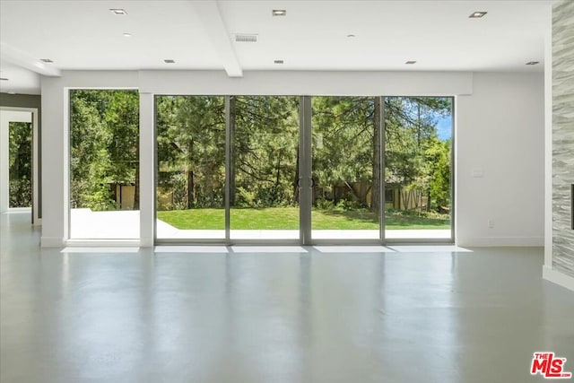 doorway to outside with beamed ceiling