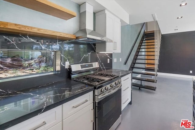 kitchen with wall chimney exhaust hood, white cabinetry, tasteful backsplash, stainless steel range with gas stovetop, and concrete flooring