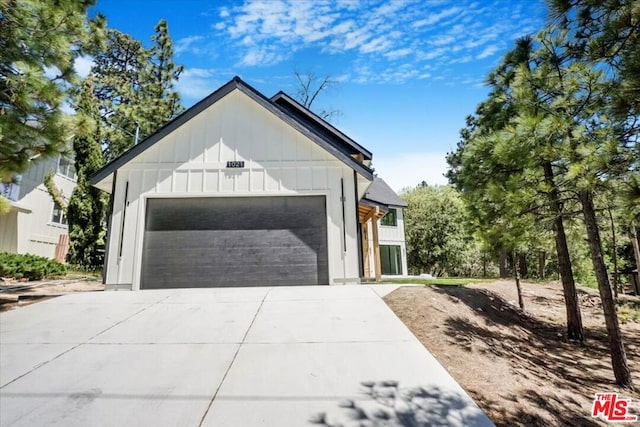 modern inspired farmhouse with a garage