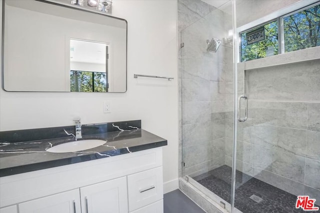 bathroom featuring an enclosed shower and vanity