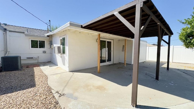 rear view of property with central air condition unit and a patio area