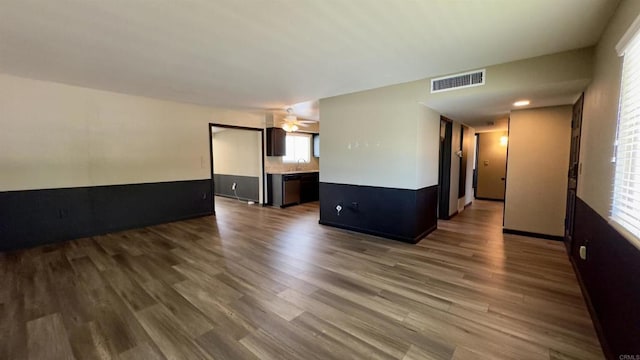 spare room featuring ceiling fan and dark wood-type flooring