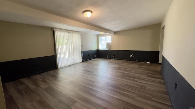 unfurnished room featuring dark wood-type flooring