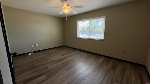 unfurnished room featuring ceiling fan and dark hardwood / wood-style flooring